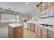 Kitchen featuring stainless appliances, center island, tile flooring and tons of natural light at 905 Star Pine Dr, Las Vegas, NV 89144