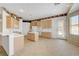 Bright kitchen featuring tile floors, wooden cabinetry, and an eat-in kitchen bar at 905 Star Pine Dr, Las Vegas, NV 89144
