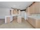 Open kitchen with wooden cabinetry, tile floors, an island, and lots of counter space at 905 Star Pine Dr, Las Vegas, NV 89144