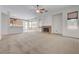 A spacious living room featuring carpet, lots of natural light, and a brick fireplace at 905 Star Pine Dr, Las Vegas, NV 89144