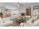 Bright living room featuring a brick fireplace, ceiling fan, and an open floor plan at 905 Star Pine Dr, Las Vegas, NV 89144
