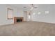 Spacious living room with carpet, a ceiling fan, and a cozy brick fireplace at 905 Star Pine Dr, Las Vegas, NV 89144