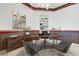 Well-appointed home office with modern decor, built-in shelving, and comfortable seating area at 905 Star Pine Dr, Las Vegas, NV 89144