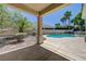 Covered patio overlooking the private pool area with lush landscaping at 905 Star Pine Dr, Las Vegas, NV 89144