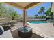 Inviting covered patio area featuring a sparkling blue swimming pool and lush landscaping for outdoor enjoyment at 905 Star Pine Dr, Las Vegas, NV 89144