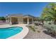 Lush landscaping around a pristine pool and patio, creating a private backyard retreat perfect for relaxation and entertainment at 905 Star Pine Dr, Las Vegas, NV 89144
