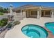 Relaxing hot tub beside a swimming pool with a built-in outdoor grill and patio for summer enjoyment and backyard barbeques at 905 Star Pine Dr, Las Vegas, NV 89144