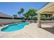 Outdoor patio with a sparkling blue swimming pool, manicured landscaping, and clear skies offering a serene retreat at 905 Star Pine Dr, Las Vegas, NV 89144