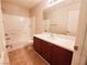 Well-lit bathroom features a tub/shower combo and a vanity with a sleek countertop and modern fixtures at 9069 Tantalizing Ave, Las Vegas, NV 89149