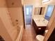 Bright bathroom features a tub/shower combo and a vanity with a sleek countertop and modern fixtures at 9069 Tantalizing Ave, Las Vegas, NV 89149