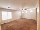 Bright bedroom with neutral walls, brown carpet, and ample natural light from the large window at 9069 Tantalizing Ave, Las Vegas, NV 89149