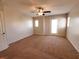Expansive bedroom with neutral walls and carpet with a ceiling fan and door leading to the backyard at 9069 Tantalizing Ave, Las Vegas, NV 89149