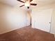 Comfortable bedroom with carpet and ceiling fan with neutral paint with an open door and closet space at 9069 Tantalizing Ave, Las Vegas, NV 89149