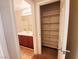 Hallway with bathroom and closet featuring multiple shelves providing plenty of storage space at 9069 Tantalizing Ave, Las Vegas, NV 89149