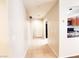Inviting hallway with neutral walls, light tile flooring, and an open view into the kitchen area at 9069 Tantalizing Ave, Las Vegas, NV 89149