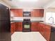 Stylish kitchen with dark cabinetry, countertops, a gas range oven, and stainless steel appliances at 9069 Tantalizing Ave, Las Vegas, NV 89149