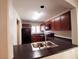 Bright kitchen featuring dark cabinets, countertops, and stainless steel appliances with a double sink at 9069 Tantalizing Ave, Las Vegas, NV 89149