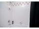Bathroom features white tiled walls, shower fixtures, and a neutral color scheme at 9660 Drayton Ave, Las Vegas, NV 89148