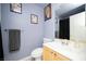 Functional bathroom with a classic vanity, toilet, and framed art at 9660 Drayton Ave, Las Vegas, NV 89148