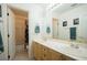 Bathroom features double sinks, spacious counter tops, white color scheme, and a view of the shower at 9660 Drayton Ave, Las Vegas, NV 89148