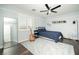 Bedroom features hardwood floors, ceiling fan, and a large window with shutters at 9660 Drayton Ave, Las Vegas, NV 89148