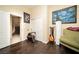 Bedroom features hardwood floors, neutral color scheme, with a view of the hallway and stairs at 9660 Drayton Ave, Las Vegas, NV 89148