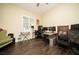 Bedroom features hardwood floors, fan, and a window with shutters at 9660 Drayton Ave, Las Vegas, NV 89148
