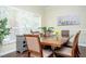 Dining area featuring a wooden table, decorative plants, and elegant shutters at 9660 Drayton Ave, Las Vegas, NV 89148