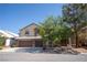 Two-story home with a three-car garage and mature tree in the front yard at 9660 Drayton Ave, Las Vegas, NV 89148