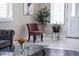 Stylish foyer featuring a modern chair, decorative plants, and white trim at 9660 Drayton Ave, Las Vegas, NV 89148