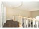 Hallway with hardwood floors, white railings, and a view of the front door at 9660 Drayton Ave, Las Vegas, NV 89148