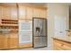 Kitchen with stainless steel refrigerator, double oven and light wood cabinets at 9660 Drayton Ave, Las Vegas, NV 89148