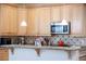 Close up of a kitchen showing the cabinets, countertop, and a microwave at 9660 Drayton Ave, Las Vegas, NV 89148