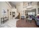 Spacious living area with a staircase, hardwood floors, and decorative columns at 9660 Drayton Ave, Las Vegas, NV 89148
