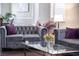 Cozy living space with modern decor and elegant gray tufted sofas at 9660 Drayton Ave, Las Vegas, NV 89148