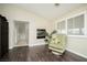 Bright living room featuring dark wood floors, modern fireplace, and large windows with plantation shutters at 9660 Drayton Ave, Las Vegas, NV 89148