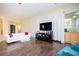 Cozy living room featuring tile and wood flooring and access to the front entry at 9660 Drayton Ave, Las Vegas, NV 89148