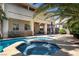 Beautiful in-ground pool and spa with a covered patio and well-manicured landscaping in a private backyard setting at 9660 Drayton Ave, Las Vegas, NV 89148
