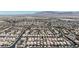 An elevated view displaying the extensive residential development, with mountain views on the horizon at 9950 Coyote Echo Ct, Las Vegas, NV 89166