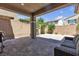 Cozy covered patio with brick pavers and a seating area, perfect for outdoor relaxation at 9950 Coyote Echo Ct, Las Vegas, NV 89166