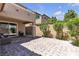 Picturesque backyard featuring a paved patio, lush landscaping, and outdoor seating at 9950 Coyote Echo Ct, Las Vegas, NV 89166