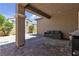 Outdoor living space with covered patio, pavers, and comfortable sofa seating at 9950 Coyote Echo Ct, Las Vegas, NV 89166