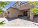 Inviting backyard with a covered patio, sliding glass doors and a well-maintained stone paver patio at 9950 Coyote Echo Ct, Las Vegas, NV 89166