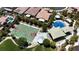 Overhead view of a green and red community basketball court, splash pad and shaded picnic area with mature trees at 9950 Coyote Echo Ct, Las Vegas, NV 89166