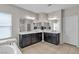 Main bathroom with double vanity, bathtub, and neutral tile floors at 9950 Coyote Echo Ct, Las Vegas, NV 89166