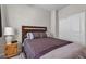 Cozy bedroom with wood-frame bed, side table, and closet with sliding doors at 9950 Coyote Echo Ct, Las Vegas, NV 89166