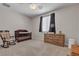 Spacious bedroom with a crib, rocking chair, and wooden dresser at 9950 Coyote Echo Ct, Las Vegas, NV 89166