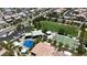 Birds eye view of community park amenities, including covered picnic area, splash pad, basketball court, and grassy field at 9950 Coyote Echo Ct, Las Vegas, NV 89166
