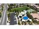 Aerial view of community park featuring covered seating, splash pad, full basketball court and mature landscaping at 9950 Coyote Echo Ct, Las Vegas, NV 89166