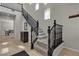 Inviting entryway with staircase, dark wood accents, and a glimpse into the dining area at 9950 Coyote Echo Ct, Las Vegas, NV 89166